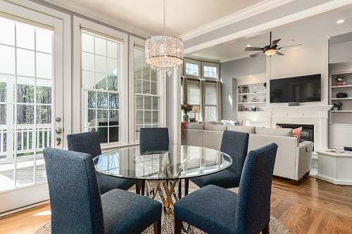 interior design round clear glass-top table and five gray chairs dining se window